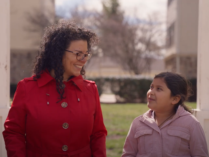 Mother and NVFS client with her daughter walking outside.